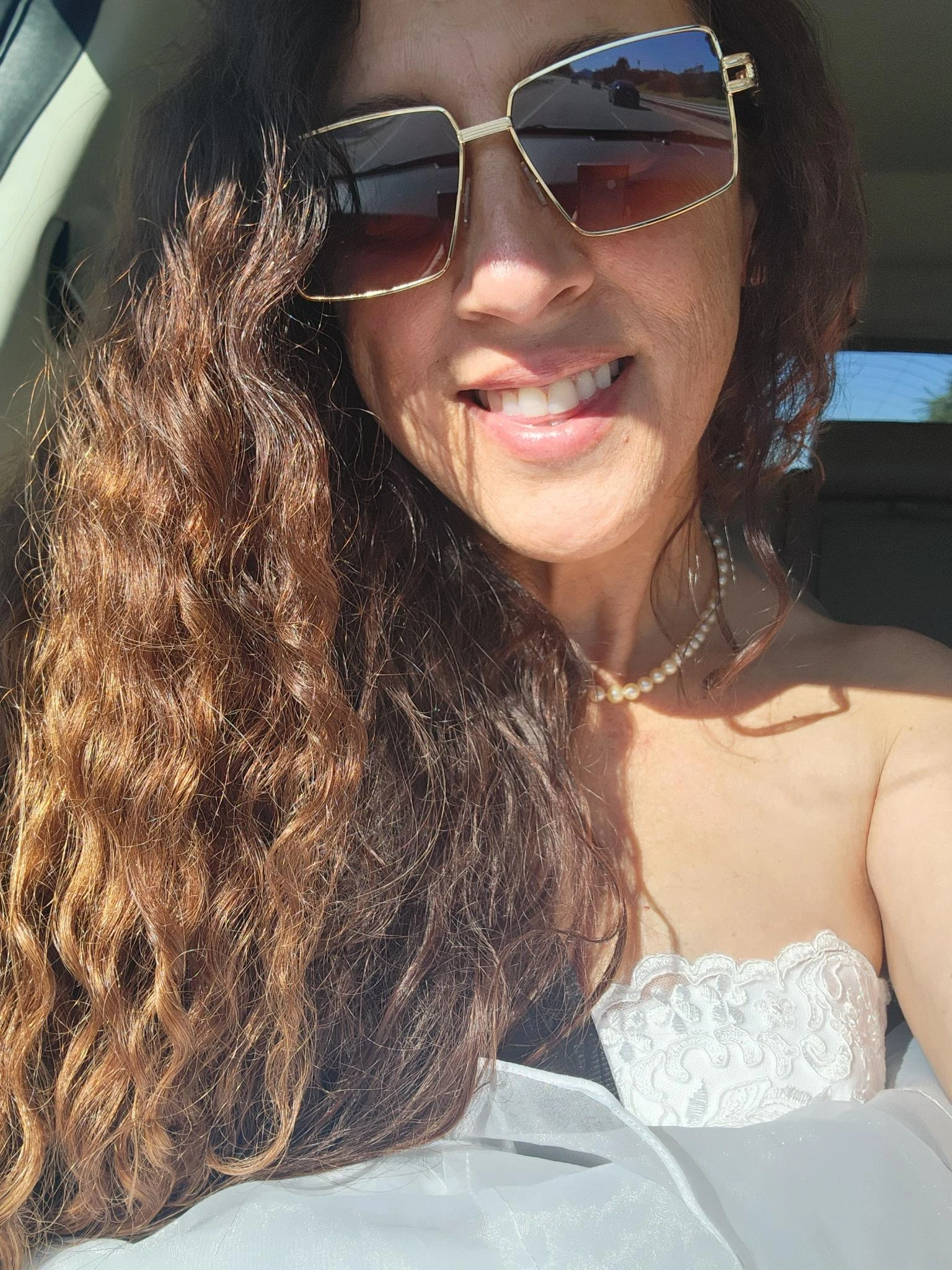 Andie smiling in her wedding dress.