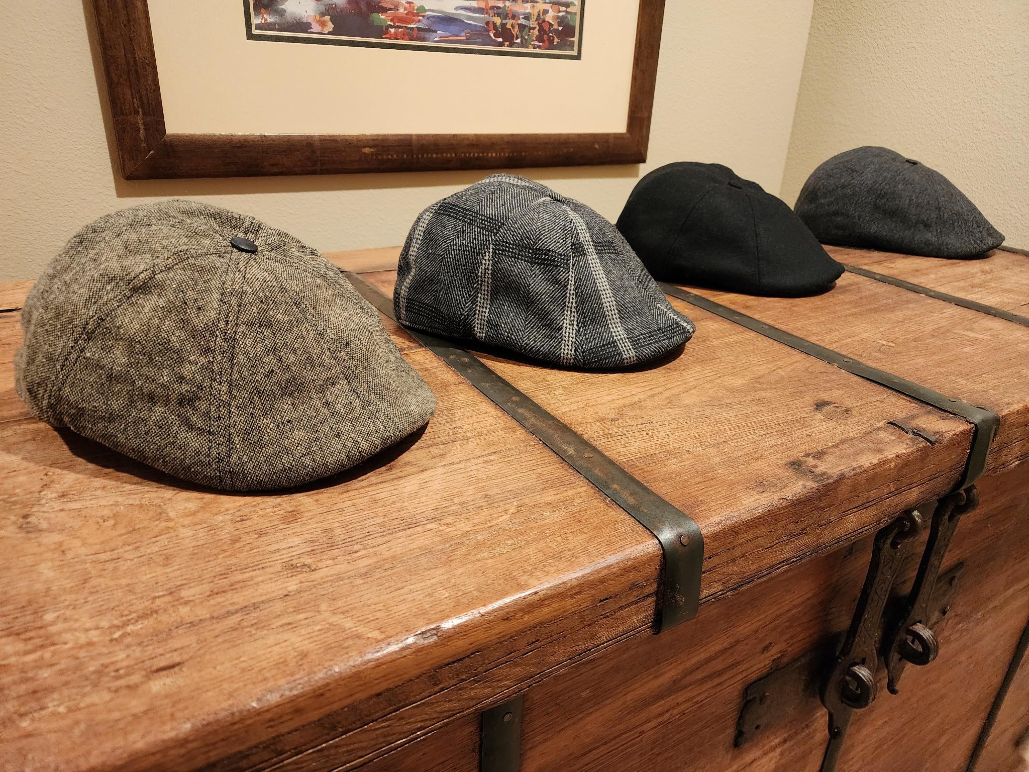 A row of Gregory’s signature flat caps