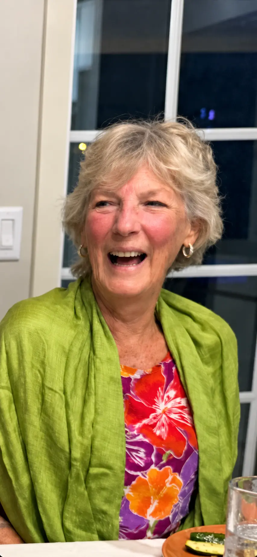 Karen laughing in a bright green wrap