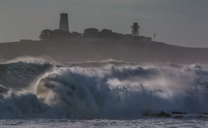 A wave rolling below Piedras Blancas and its lighthouse