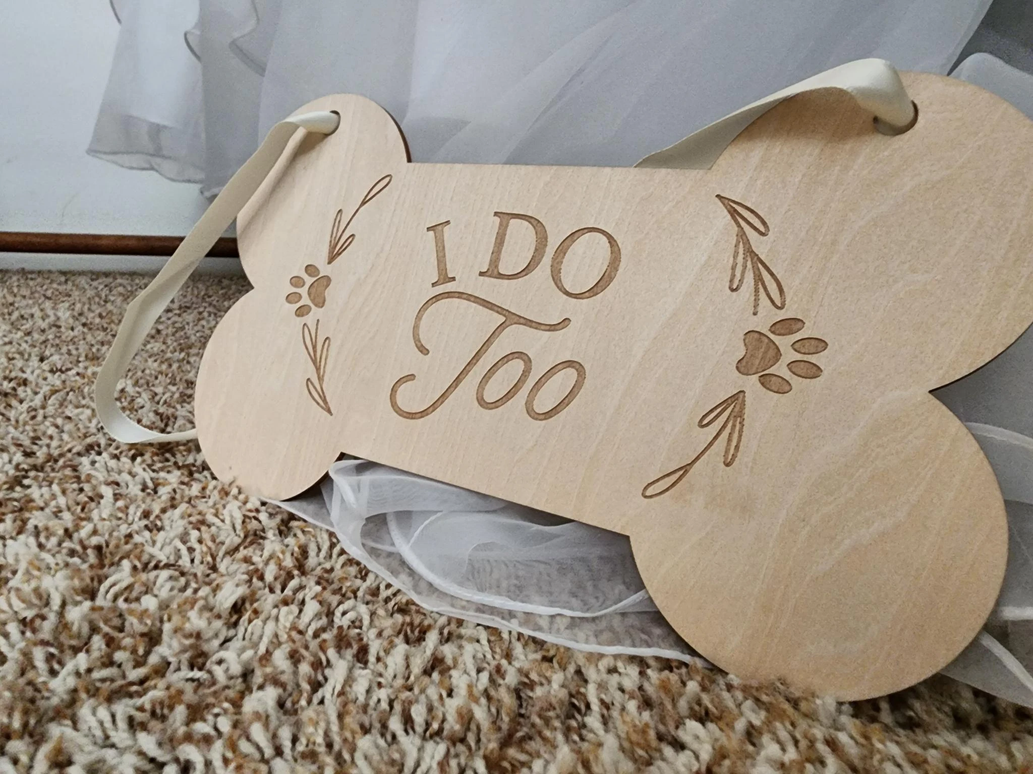 Piper’s wooden bone, engraved I DO TOO.