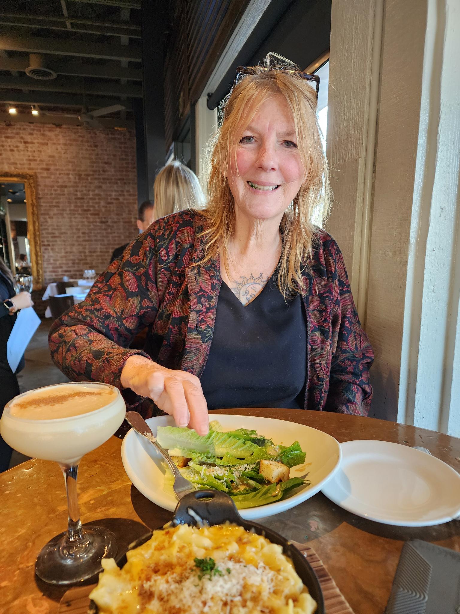 Andie’s mama smiling at a restaurant table
