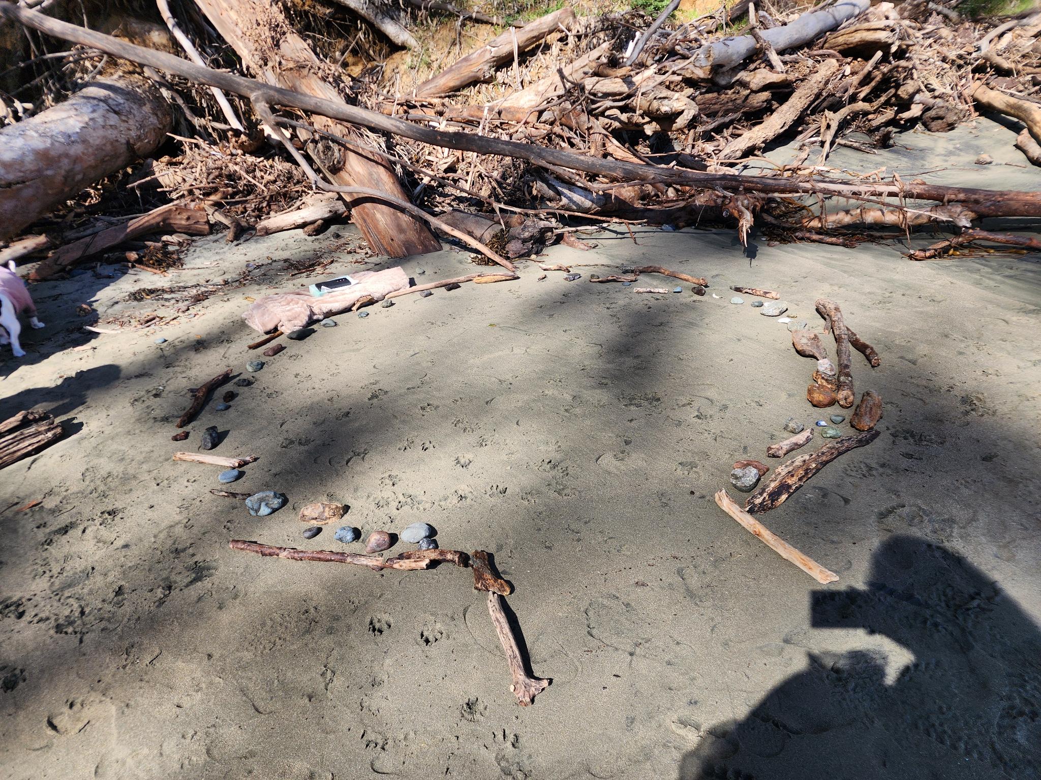 Our circle of sticks and stones on the untouched sand