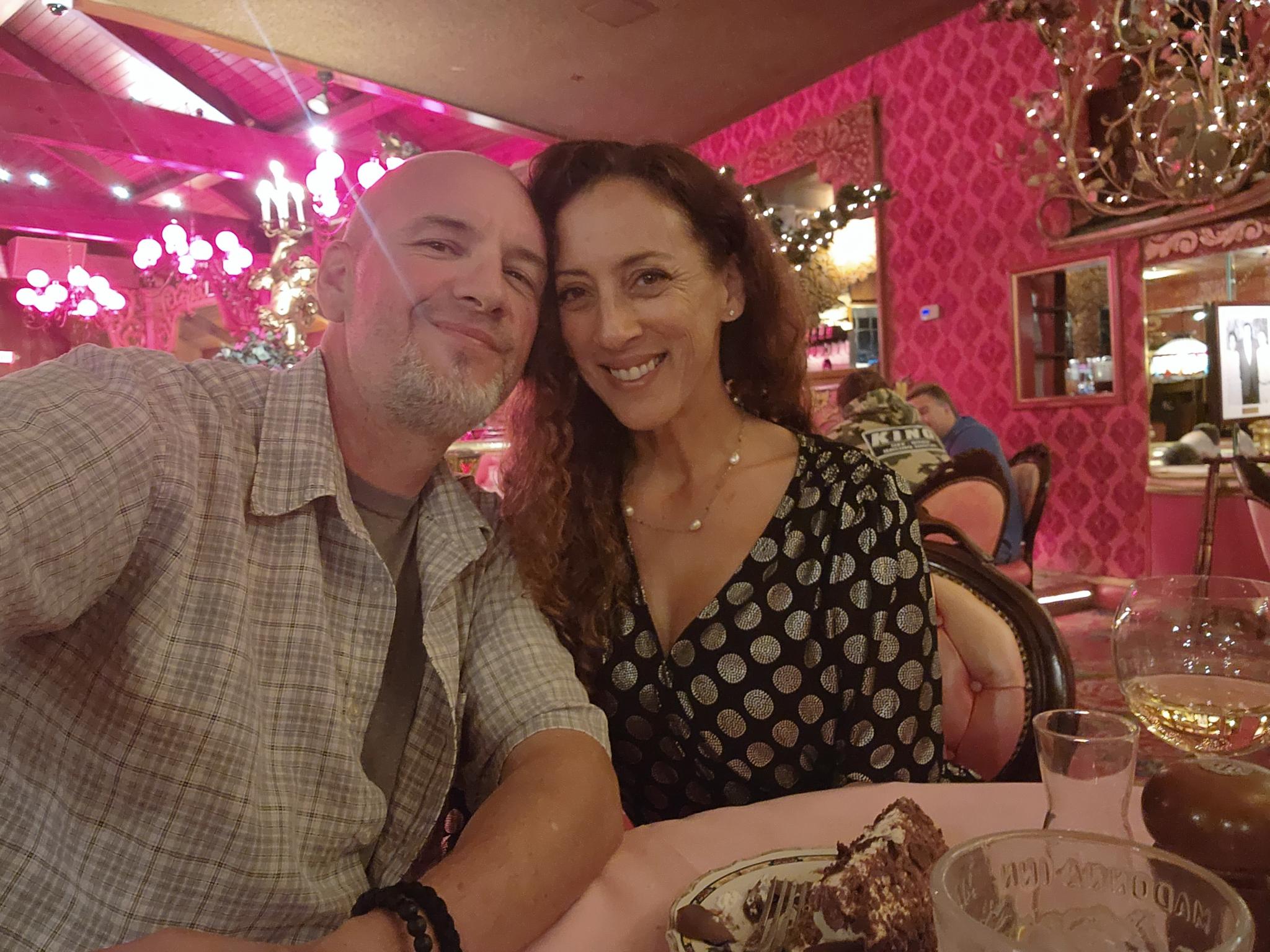 Andie and Greg smiling together on a date
