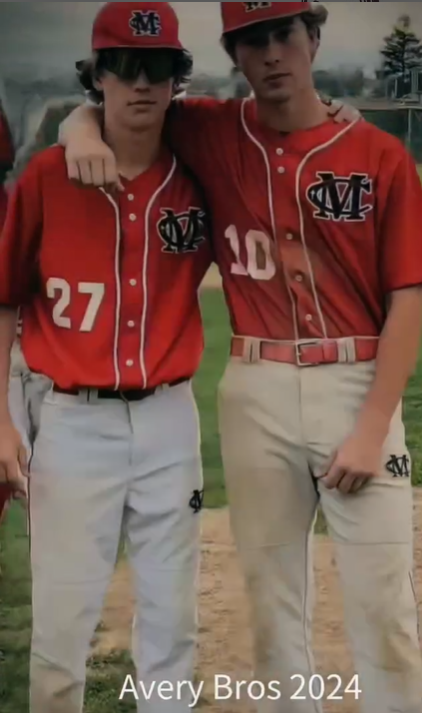 Two of Andie’s boys standing together in baseball uniforms