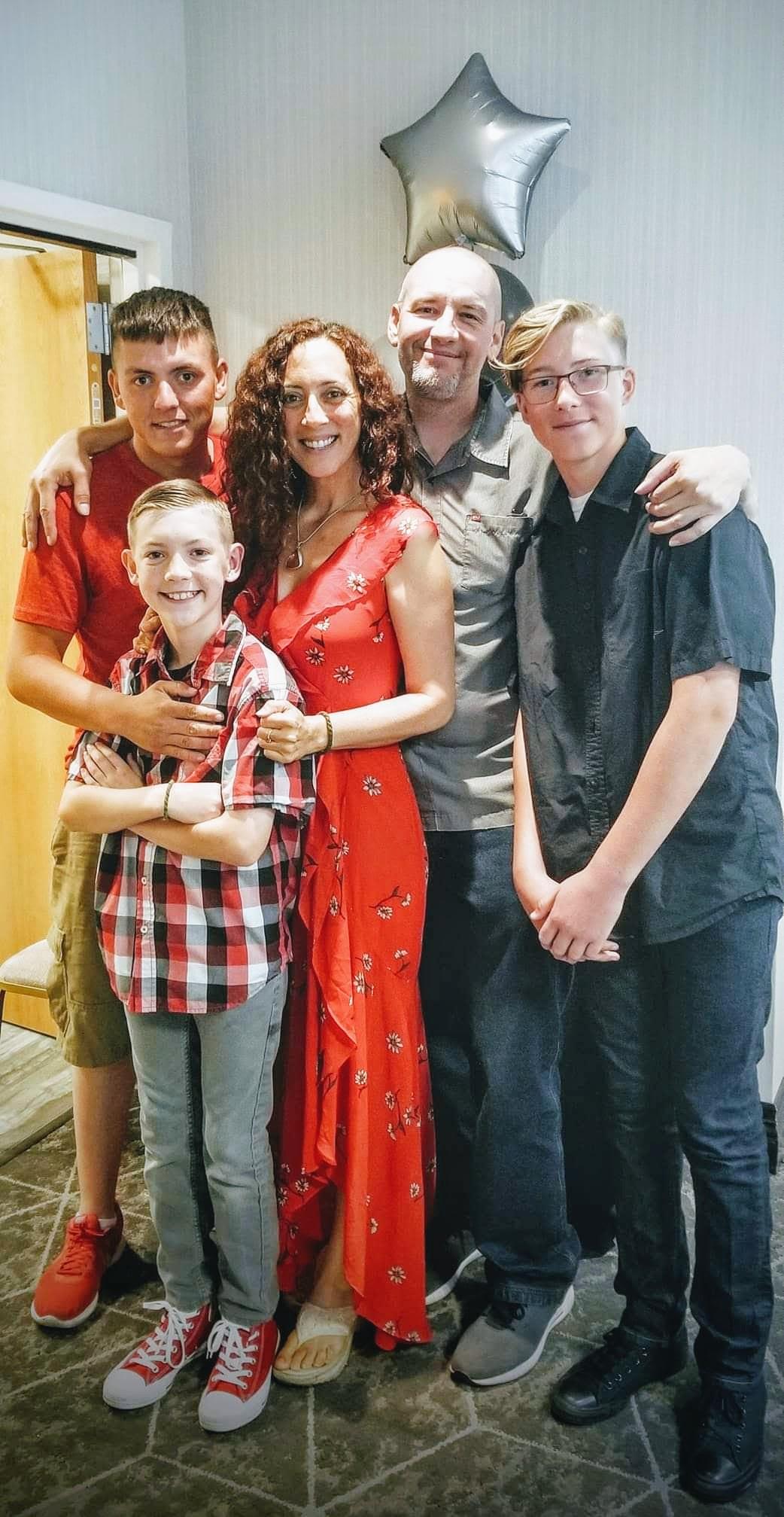 Andie and Greg standing with members of their family