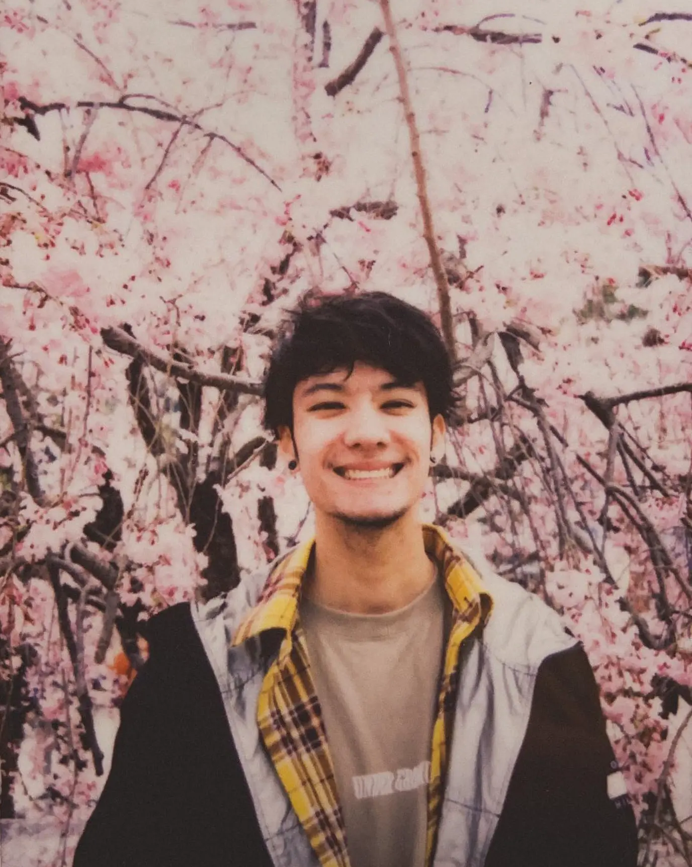 Kyoji standing beside flowering trees