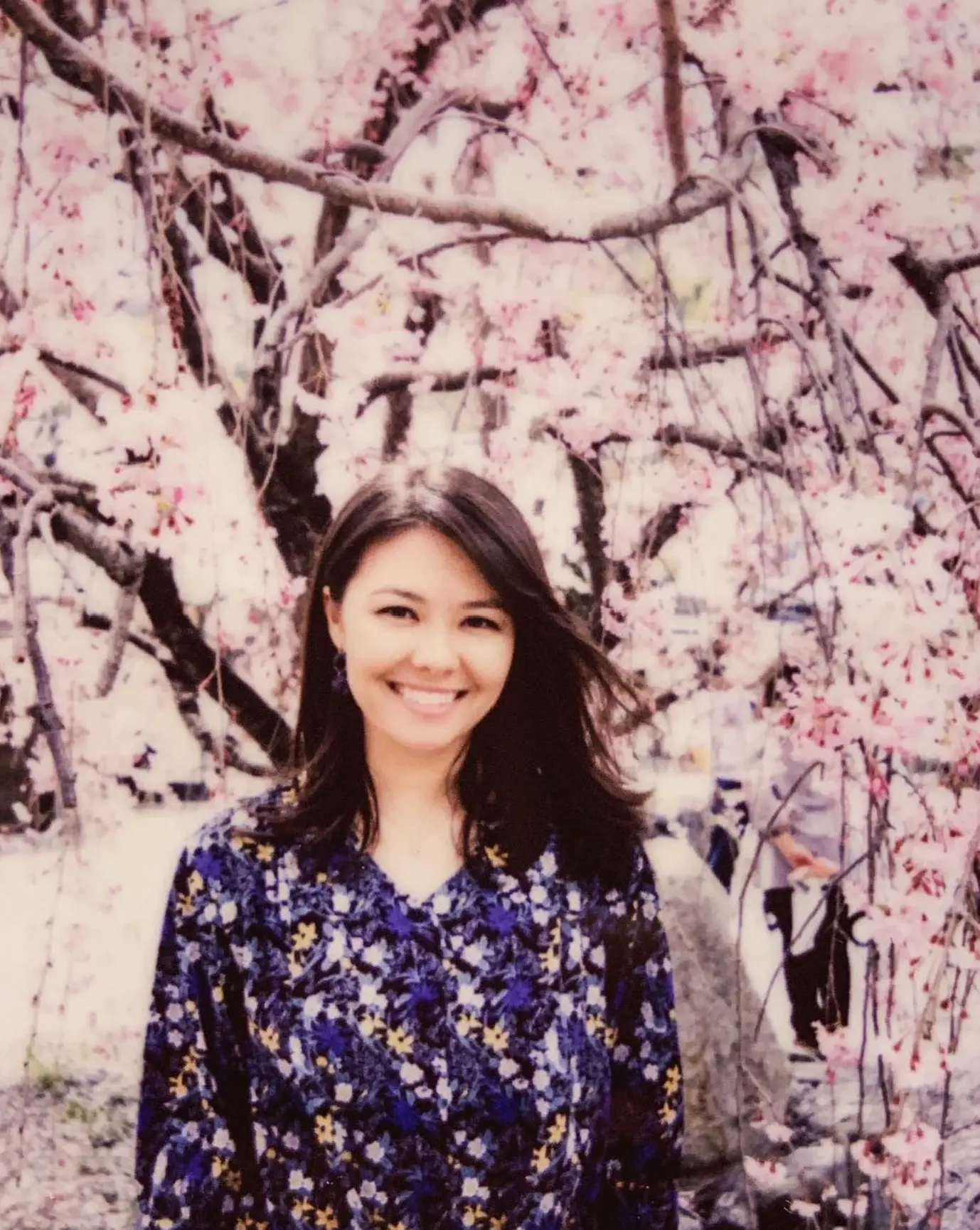 Victoria standing beside flowering trees